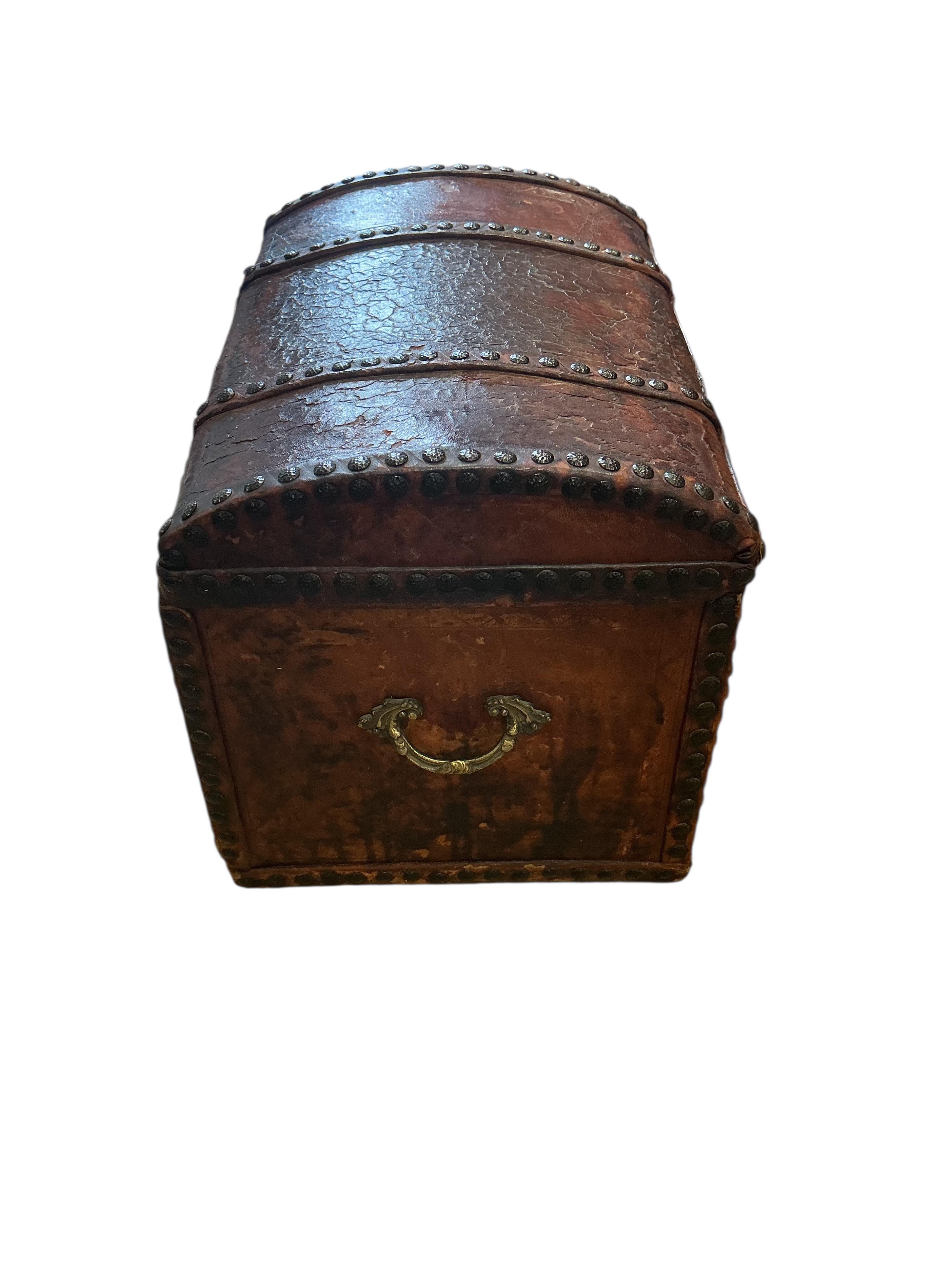 A small 18th century style studded domed top leather covered trunk with internal drawers, width 50cm, depth 35cm, height 37cm